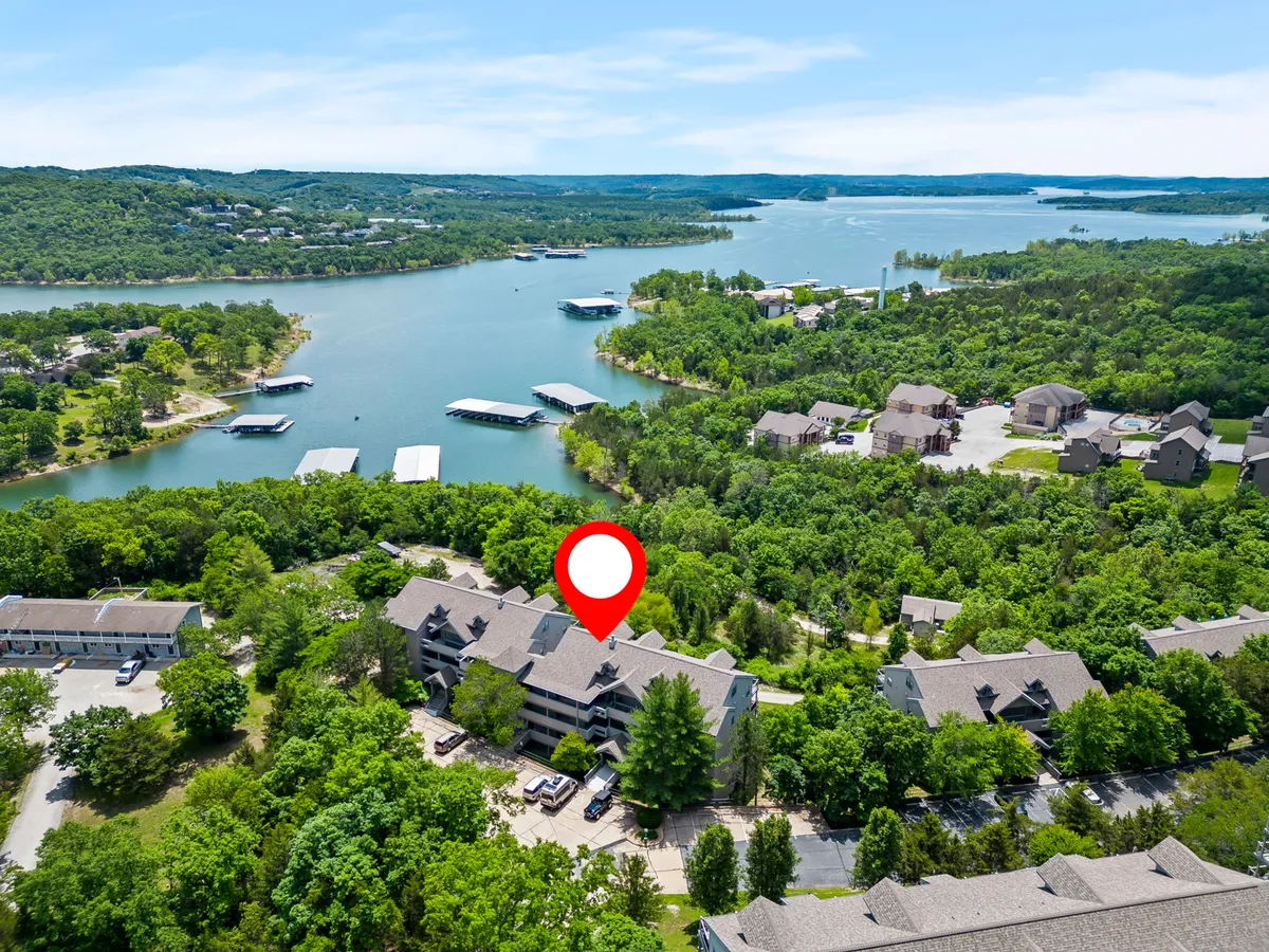 A wide-angle exterior view of the lake, surrounded by lush greenery and boats on the water. The scene is tranquil, inviting, and highlights opportunities for boating, fishing, hiking, or lakeside picnics—activities mentioned in the section content.